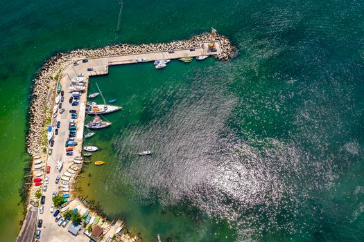 Aerial top view from drone to the seacoast and the marina with boats and yachts. Sea landscape with yachts from above