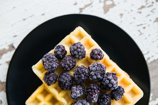 Delicious and beautiful Belgian waffles with blackberries, close-up.