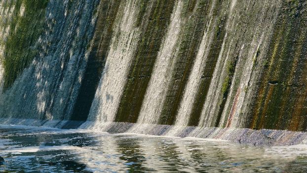 a barrier constructed to hold back water and raise its level, forming a reservoir used to generate electricity or as a water supply.