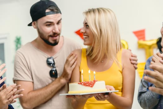 Friend surprise woman with birthday cake and party to beautiful women she very happy and smile.