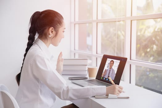 Woman greeting video call with doctor from internet channel staying at home. Girl teen patient in video conferencing with general health practitioner or online personal healthcare for consult.