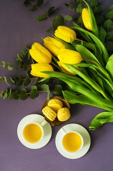 yellow tulips, cookies and two cups of tea in bed