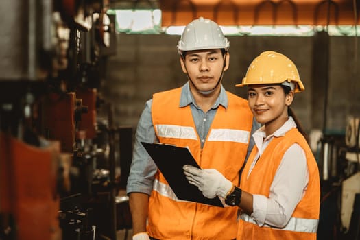 Engineer team male working with women work help support together in heavy industry teach and training machine operation in factory