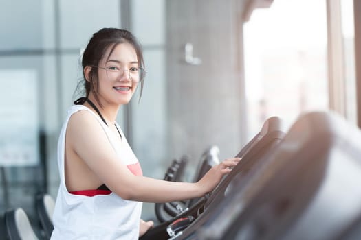 cute healthy teen girl happy smile exercise in sport club in the morning.