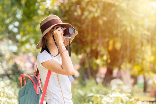 female girl teen take a photo while holiday travel outdoors in park nature background.