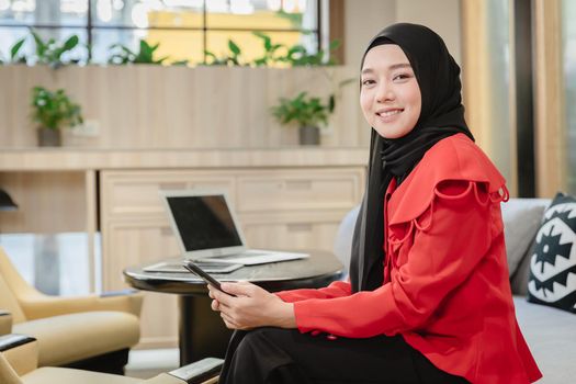 Arab Muslim businesswoman girl smiling sitting portrait in business office,Islam working woman concept
