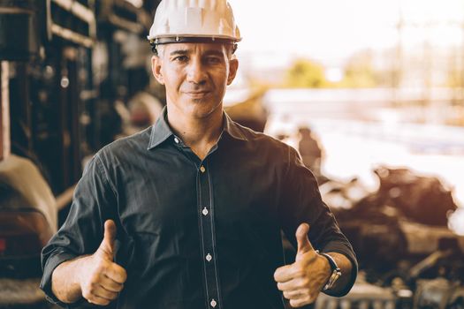 Professional adult Engineer male work in factory standing hands show two Thumbs up for good job or best working with confident smile
