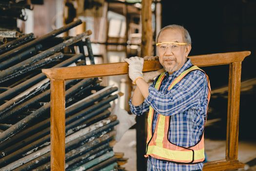 Healthy strong elder old man worker hard working in construction site with protection safety.