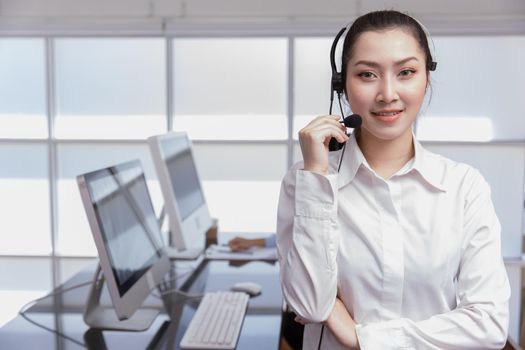 Portrait Asian women business office call center operator. Helpdesk support phone call team worker female teen smile with microphone headset. Telesale marketing agents people.