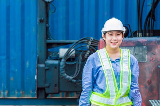 Portrait of Asian young teen happy smile worker working in shipping port manage import export cargo containers.
