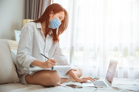 Girl teen education or working at home during covid self quarantine, ware face mask learning online.