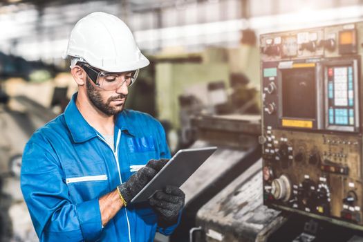 engineer setup the CNC machine with G-Code programming upload from Computer Tablet for technology in heavy industry.