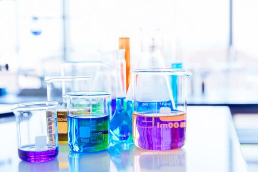 Colorful mix chemical in science glassware flask at lab science. beautiful chemistry laboratory background.