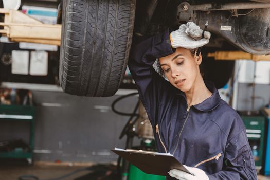 black women worker staff hard working at the garage car checking feel hot and tired uncomfortable