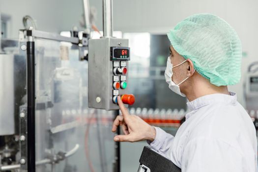 Staff workers working operate control machine in hygiene food factory.