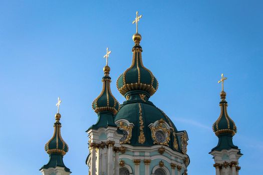 Green domes of the Kiev-Pechersk Lavra church against the blue sky. High quality photo