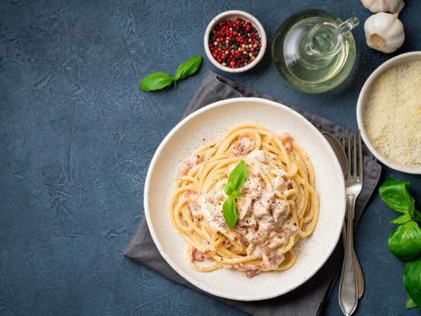 Carbonara pasta. Spaghetti with pancetta, egg, parmesan cheese and cream sauce. Traditional italian cuisine. Top view, copy space.