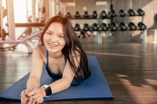 Portrait healthy lifestyle Asian women slim happy smiling in fitness sport gym.