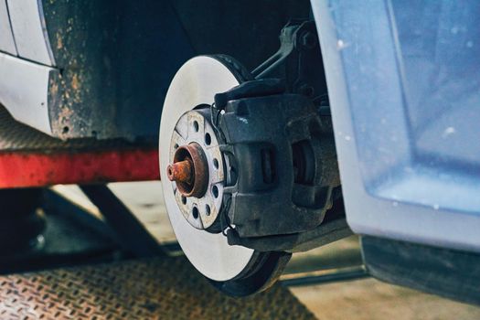 Replacing a car wheel at a tire station. a rubber covering, typically inflated or surrounding an inflated inner tube, placed around a wheel to form a flexible contact with the road.