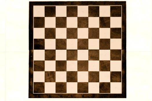 a square board divided into sixty-four alternating dark and light squares, used for playing chess or checkers.