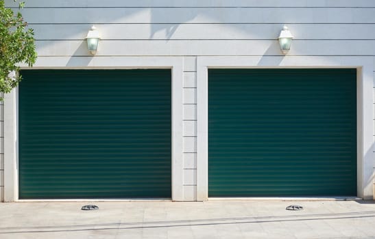 Garage with automatic rolling gates for two cars.