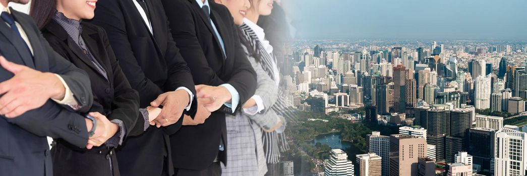 Successful business people standing together showing strong relationship of worker community. A team of businessman and businesswoman expressing a strong group teamwork at office broaden view