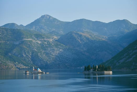 Two islands in the sea with mountains in the background in Montenegro, Perast.