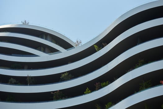 Facade of a modern apartments building in europe with plants.