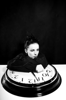 sad woman with big clock, black background. High quality photo