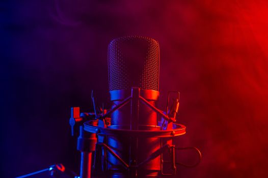 Professional microphone in pink smoke on a black background