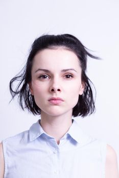 woman in a blue sleeveless office shirt, light background. High quality photo