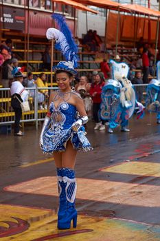 ORURO, BOLIVIA - FEBRUARY 25, 2017: Female Morenada dancers in colourful costumes parading through the mining city of Oruro on the Altiplano of Bolivia during the annual Oruro Carnival.