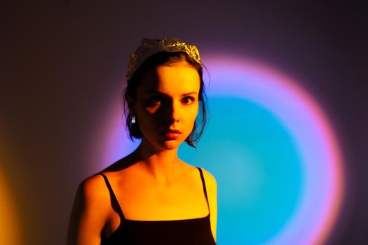 woman with a crown on her head in yellow light, art portrait. High quality photo