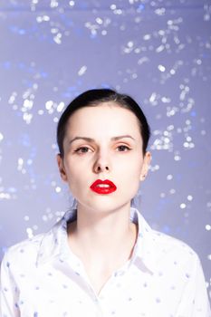 art portrait of a woman with red lipstick on her lips in a white shirt. High quality photo