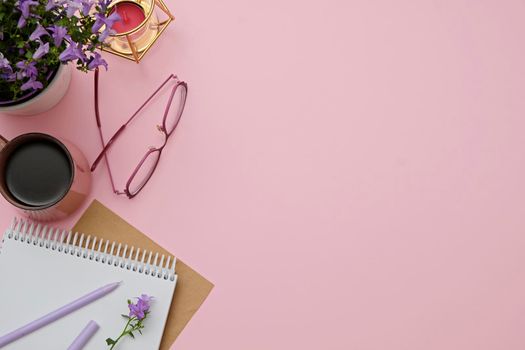 Flat lay modern workspace pink desk with notepad, glasses, coffee cup. Business lady blog hero concept.