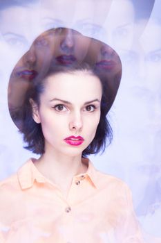 woman with pink lips in a hat on a blue background, art portrait. High quality photo