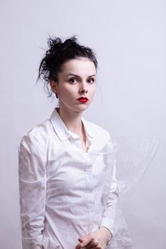 woman with red lips in a white shirt. High quality photo