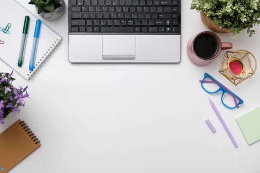 Flat lay workspace desk with laptop, glasses, smartphone, coffee cup. Business lady blog hero concept.