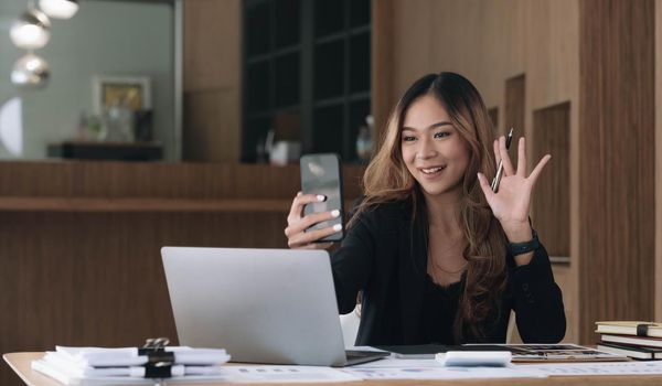 Video presentations conference young Asian businesswoman presenting presentations using video call at office..