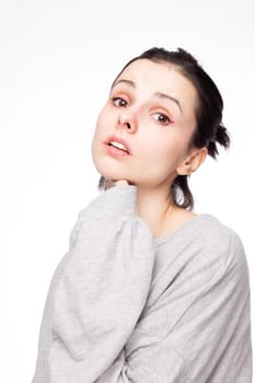 emotional woman in a gray sweatshirt, white background. High quality photo