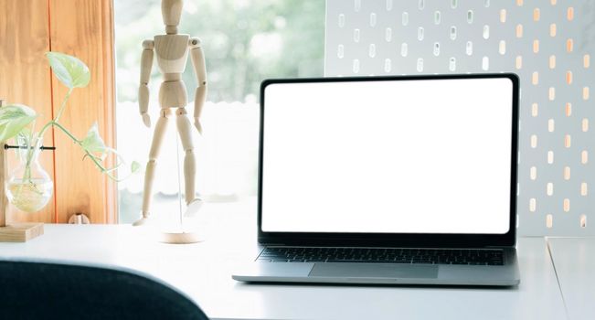 Mockup blank screen laptop on desk. Workspace with laptop and office supplies..