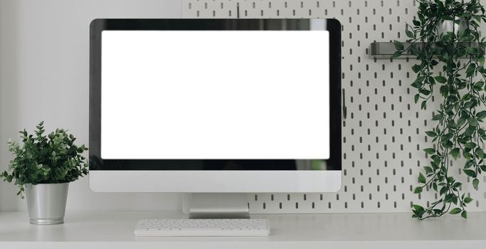 Mockup blank screen laptop on desk. Workspace with laptop and office supplies..