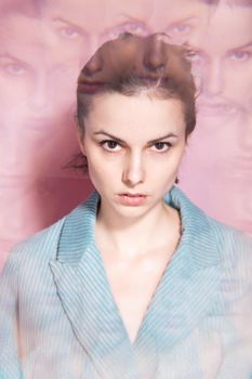 art portrait, a woman in a blue jacket on a pink background. High quality photo