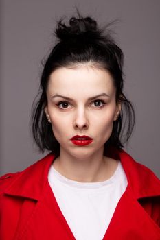 brunette woman in white t-shirt, red jacket. High quality photo