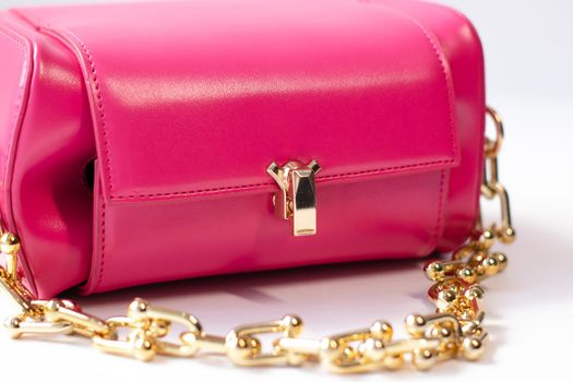 pink little handbag with gold chain isolated on white background. Product photography. bags and purses.