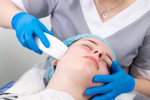 Young woman receiving electric galvanic anti-aging face spa massage at beauty salon. Galvanic massage helps to speed up metabolism, improve regeneration and restore skin protection from harmful external factors.