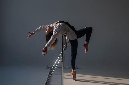 Caucasian woman posing at the ballet barre