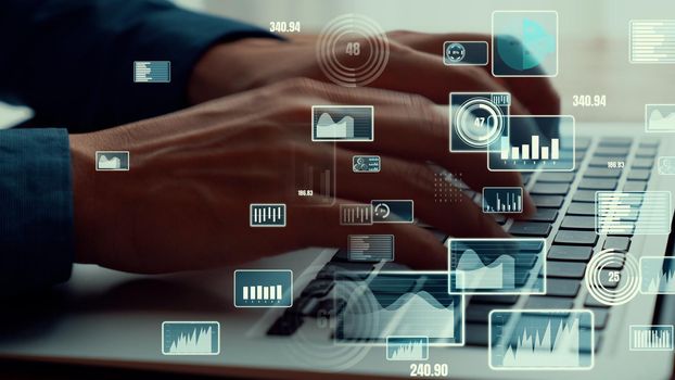 Businessman uses capable laptop computer to analyze business data analytic for marketing strategy and customer relationship management