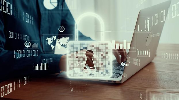 Businessman uses capable laptop computer to manage cyber security system for defending computer virus , computer crime and hackers in order to maintain security of cyber business