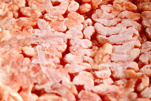 Frozen red minced meat close up, background. Out of focus, blurred